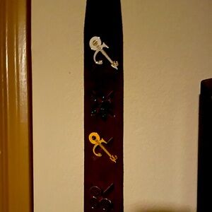 Purple leather guitar strap featuring 0(+> symbols